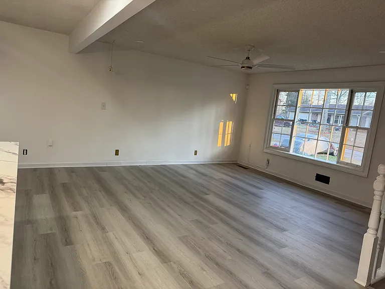 new floors throughout the house. living room with bay window