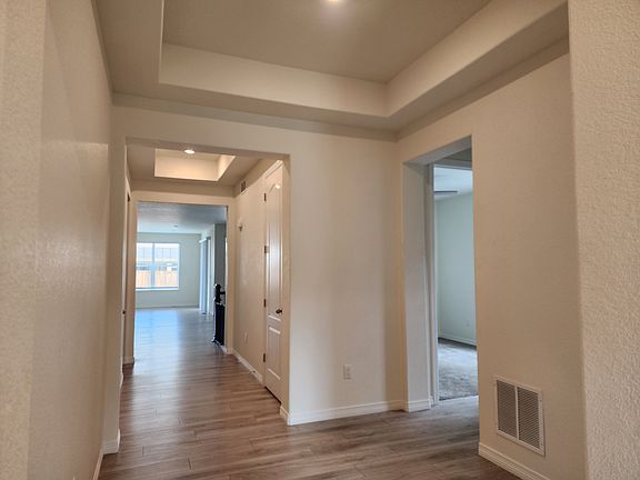 Front hallway with 2 bedrooms to the right and a full bath in between