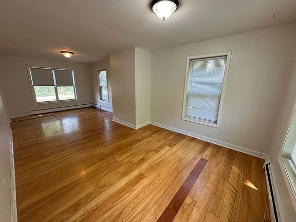 Living room from kitchen threshold towards front yard