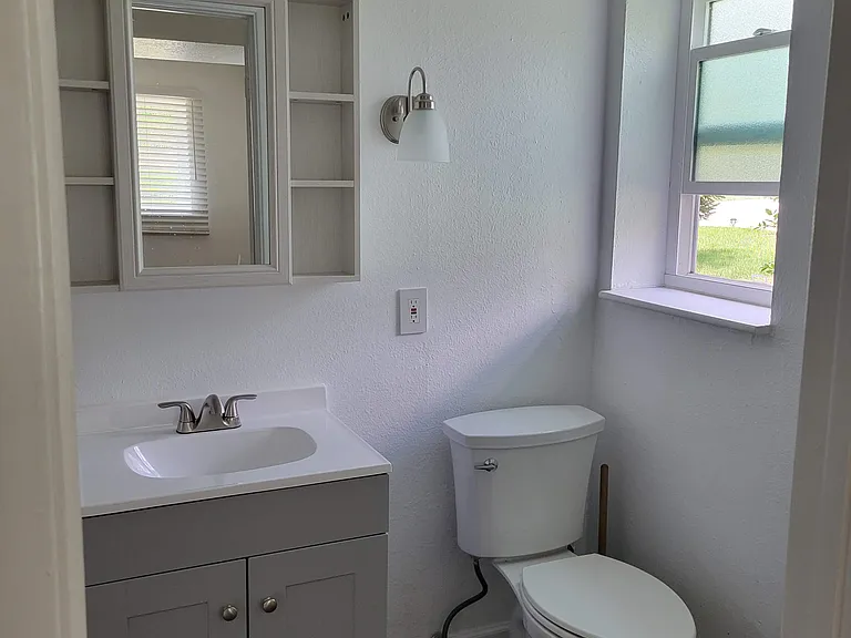 Downstairs newly remodeled primary ensuite 3/4 bath with natural light
