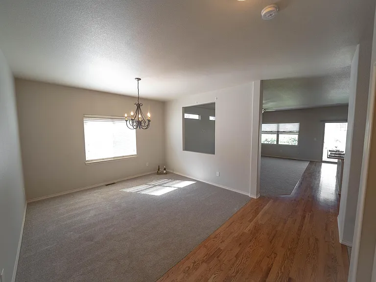 The dining room with opening to the family or great room - notice a hallway on the right