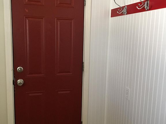 Backdoor, room for washer, dryer located opposite wall with hooks. Outside door, porch. From porch access to single car garage.