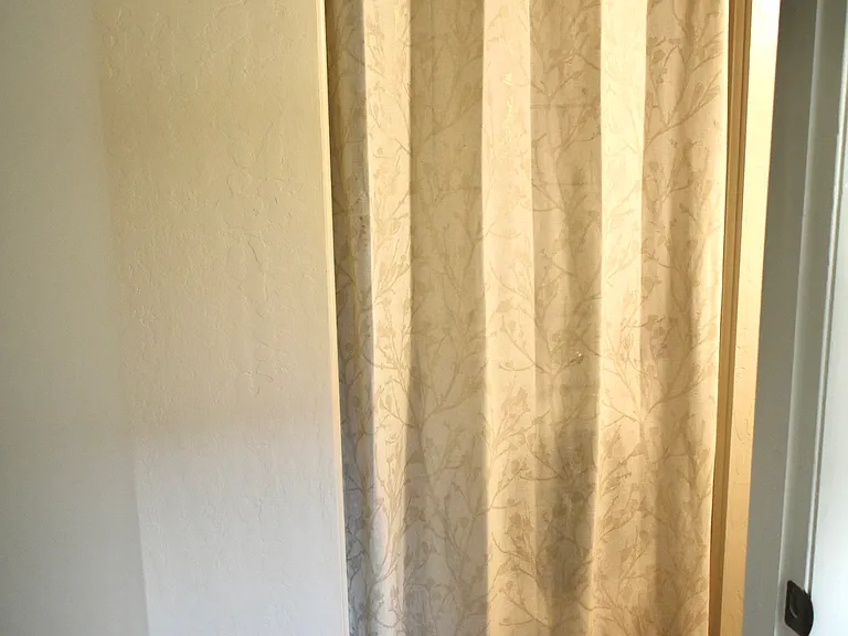 Hallway view from 3rd Bedroom - Behind the curtain is a full-size washer & dryer