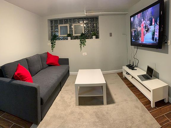 main living area with pull out couch which converts to a queen sized bed. 55inch smart TV