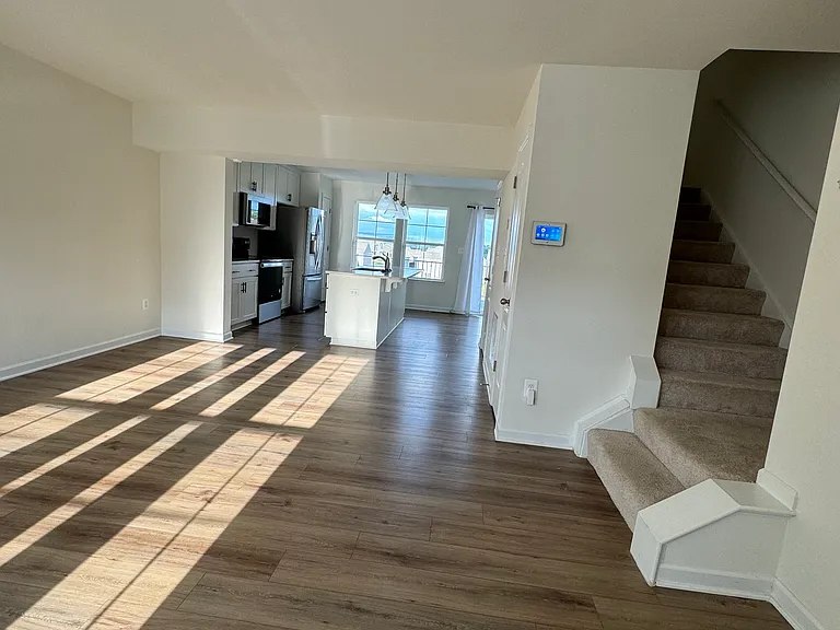 Living space with stairs leading to upstairs rooms