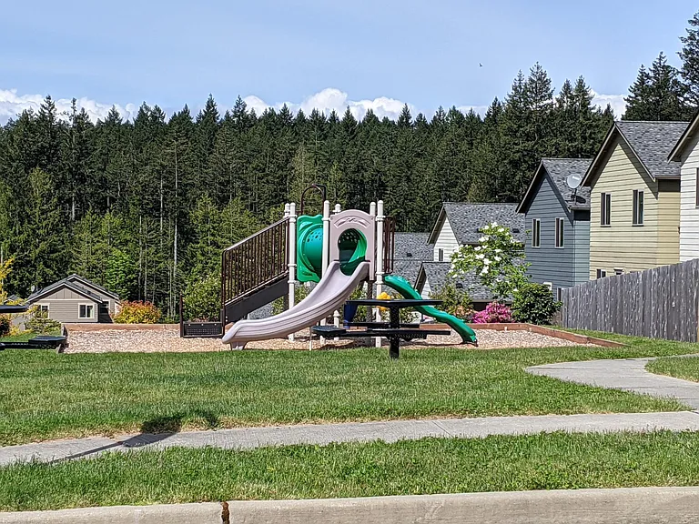 Private community playground, covered picnic gazebo, swing set.