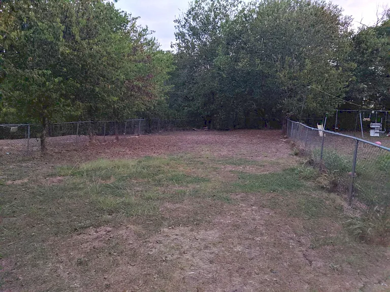 Very large backyard is fully fenced and not shared. Peaceful woods and dry creekbed beyond the fence. No neighbors behind you