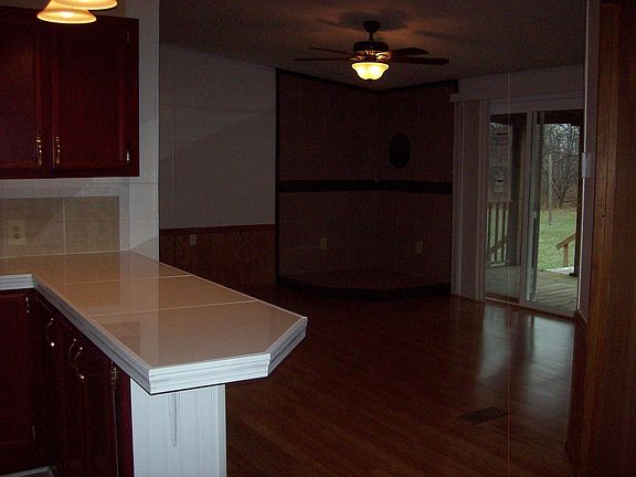 Open concept kitchen with family room looks out on back covered deck