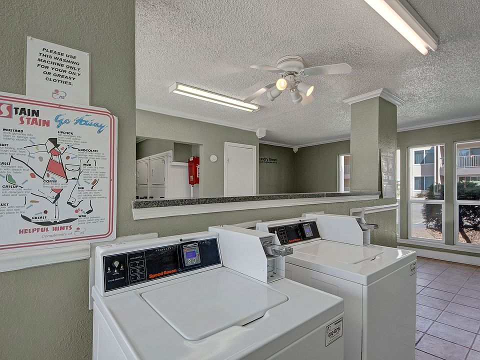 The shared laundry room with multiple washers and dryers for resident use