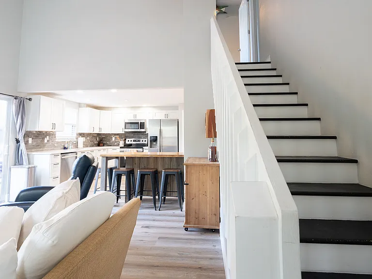 Stairs to master suite, open floorplan living room