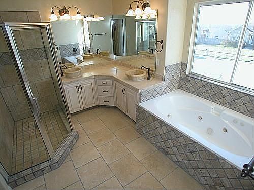 Designer master bath w/ travertine throughout and custom bowl sinks