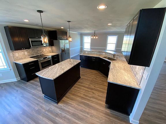 Kitchen with granite tops and backsplash