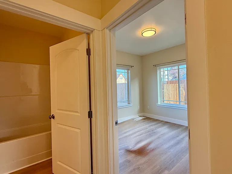 Second bedroom beside main bathroom with tub/shower
