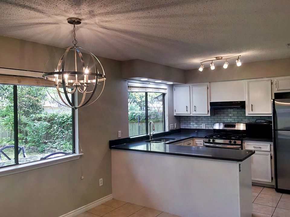 Newly renovated kitchen with stainless steel appliances, new countertops, fixtures, and open format. Dining area and kitchen with a splendid view of amazing backyard.