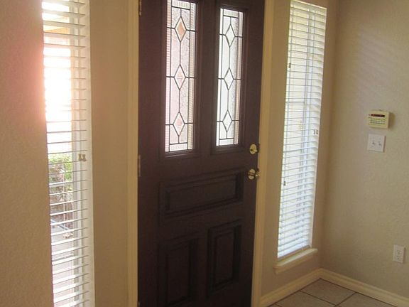 Inside front tiled entry. Wood shades throughout!