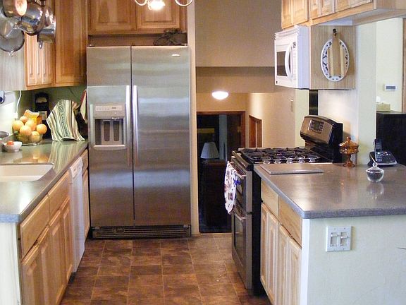 Open Kitchen w/ stainless steel appliances 