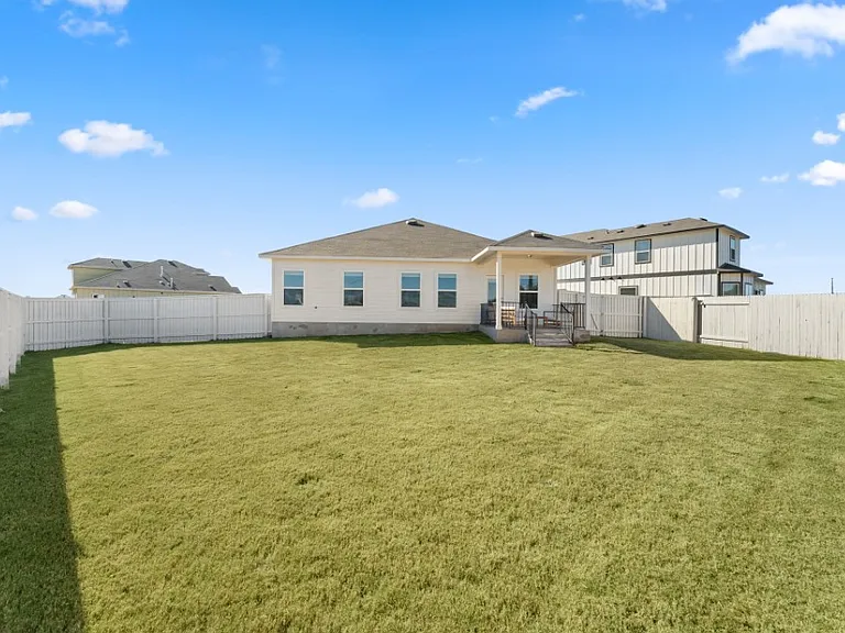From the spacious living area, there is a door that leads to the large back yard.