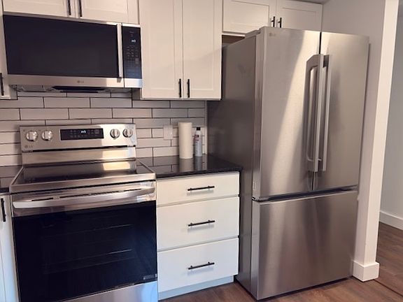 Kitchen area with large window and room for a table and chairs.