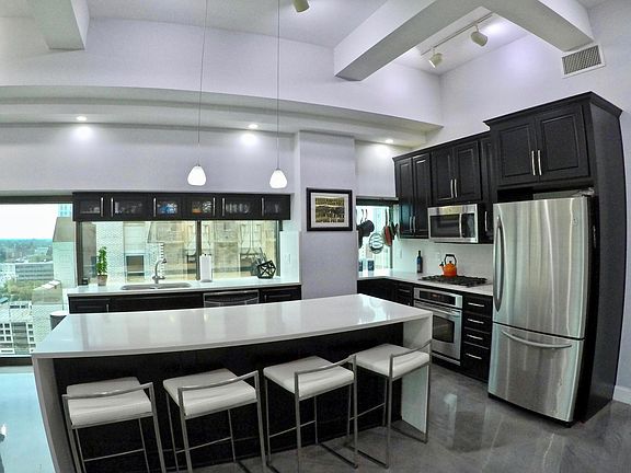 Kitchen is fully-stocked with cookware and dining ware.