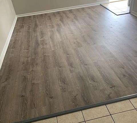 Luxury Vinyl tile in Living area, 
Tile in Dining and Kitchen area.
