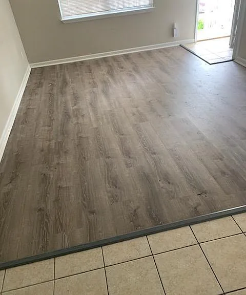 Luxury Vinyl tile in Living area, 
Tile in Dining and Kitchen area.