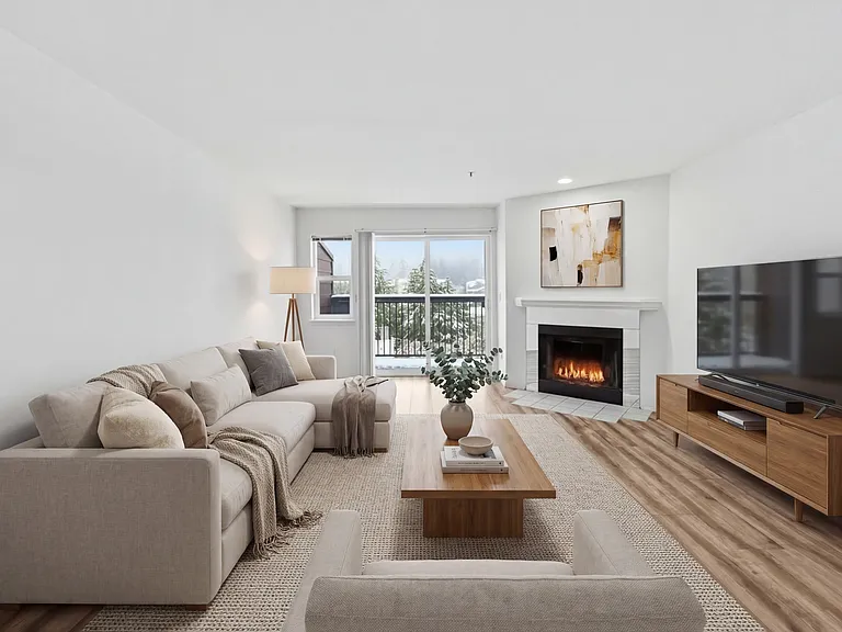 Spacious living area with new flooring throughout and cozy fireplace