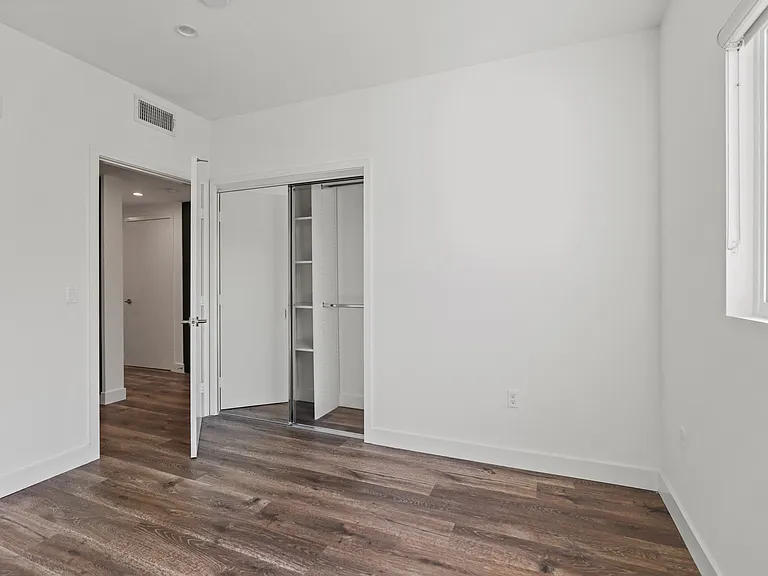 Bedroom with Vinyl Flooring, Recessed Lighting, Closet, and Window