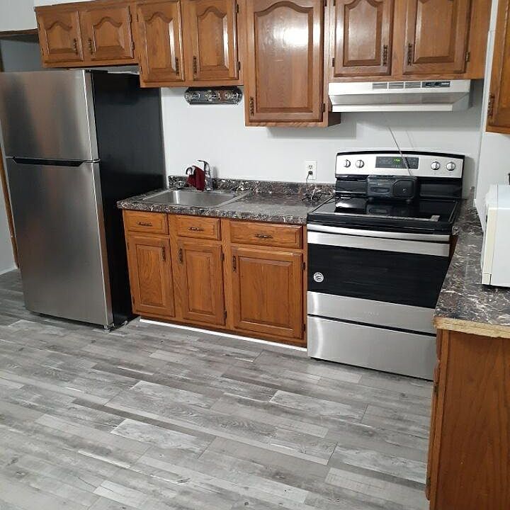 Renovated kitchen with new Stainless-steel appliances and new Nucor floor tiles.