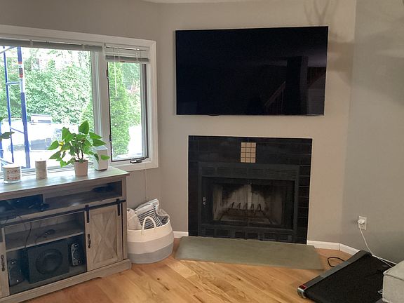 View of wood burning fireplace and window look in out to private deck