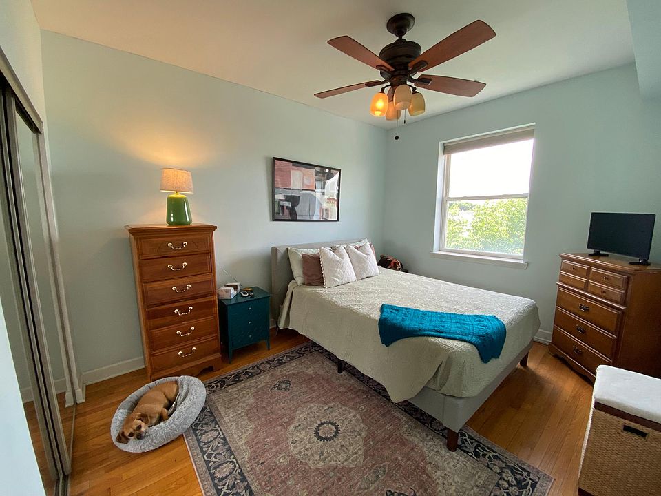 Master bedroom w/ fan, blackout shade, and mirrored closet door (previous listing)