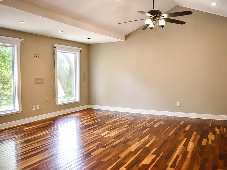 Open-concept living space with vaulted ceilings and warm hardwood flooring.