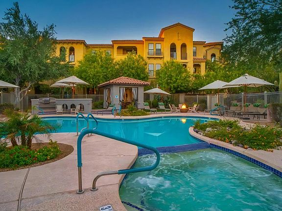 Swimming Pool Connected to Hot Tub with Poolside Firepit and Umbrellas