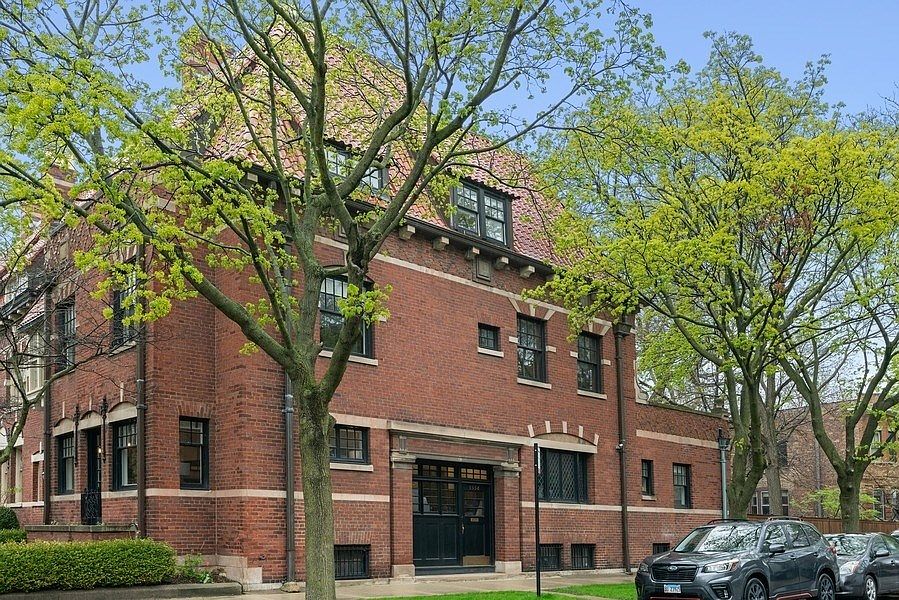 Nestled beneath a steeply pitched tile roof is a h