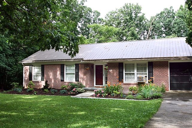 Front exterior. Beautifully wooded, quiet street near Nellie