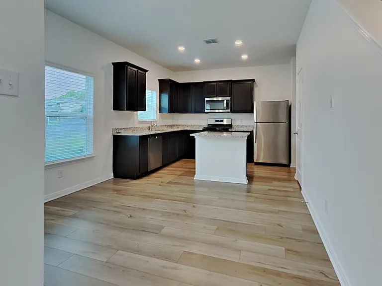 Spacious kitchen with dark cab
