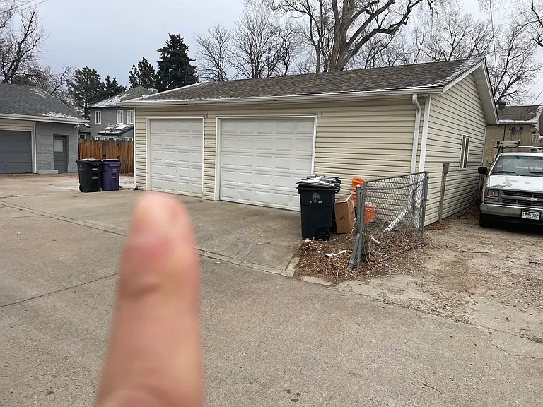 Oversized shared 2 car garage. North garage door for this unit. Great storage. Spare off-street parking to the right at first come first serve/coordination with other unit renter