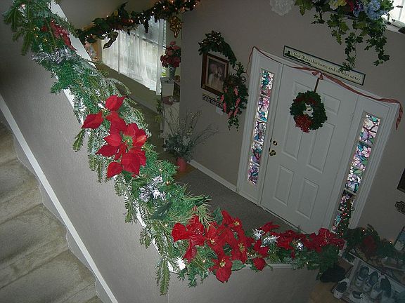 Inside looking over banister from loft to the foyer