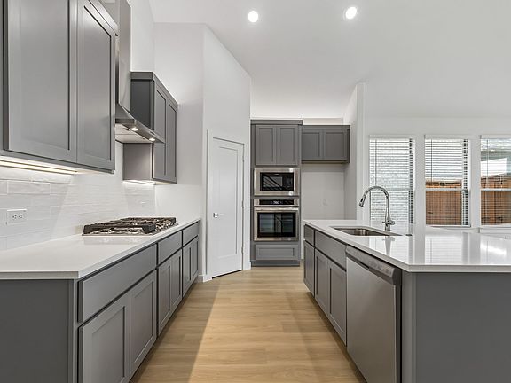 Kitchen in the Claret home plan by Trophy Signature Homes - REPRESENTATIVE PHOTO