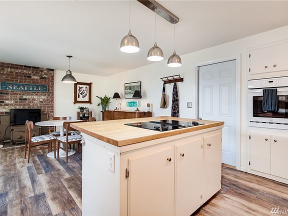 Center island with glass cooktop and butcher block counter