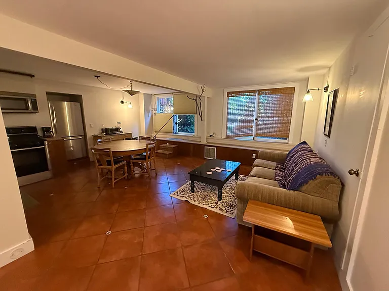 Living area with windows that open to backyard and back door