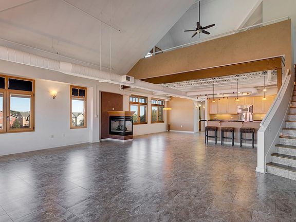 Living area with stairway to loft