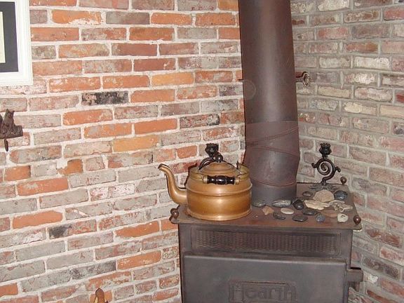 Fabulous Wood Stove with Exposed Brick Wall in Kitchen