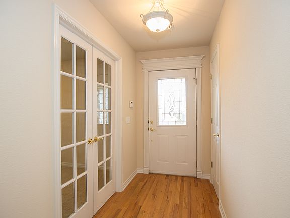 Hallway with hardwoods Office entrance on right of front door