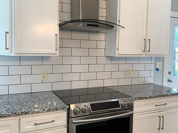 Side in convection oven in gourmet kitchen makes cooking and entertaining easy. Side door to side yard can be viewed on the right of this picture.
