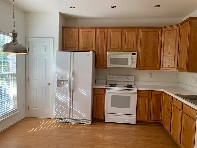 Large spacious kitchen with ample cabinet storage, Pantry, appliances, natural light. It can easily hold a small dining table