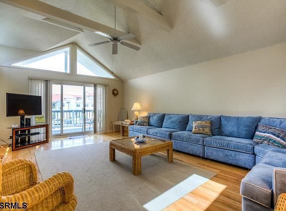 Bright an Airy Living Room With Exposed Wood Beams and Gas Fireplace