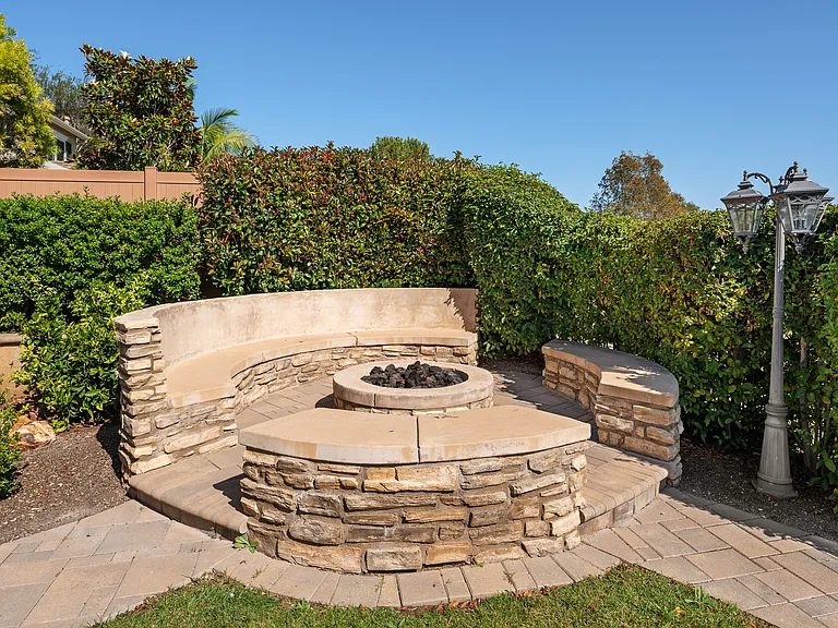 Professionally Landscaped Gas Firepit and Built-in Sitting Area and Malibu Lightings.