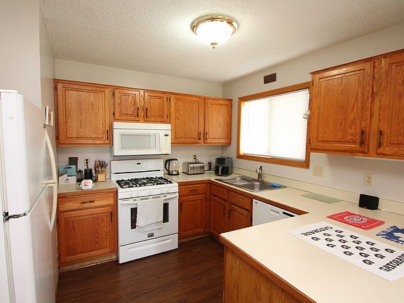 The kitchen features plenty of cabinets and counter space.