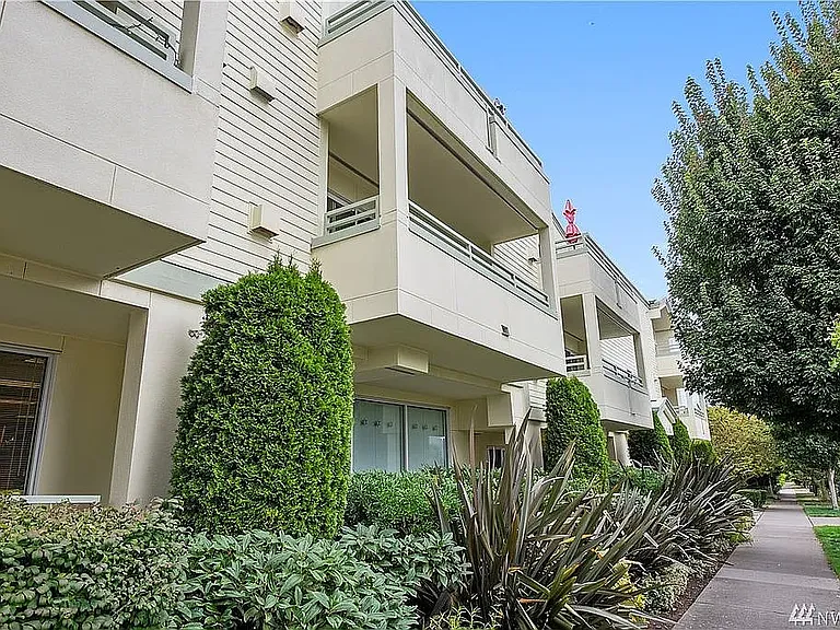 Curb view, looking down 63rd - unit's patio is the one pictured with the red umbrella