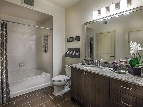 Spa-like bathrooms feature framed mirrors and oversized tubs